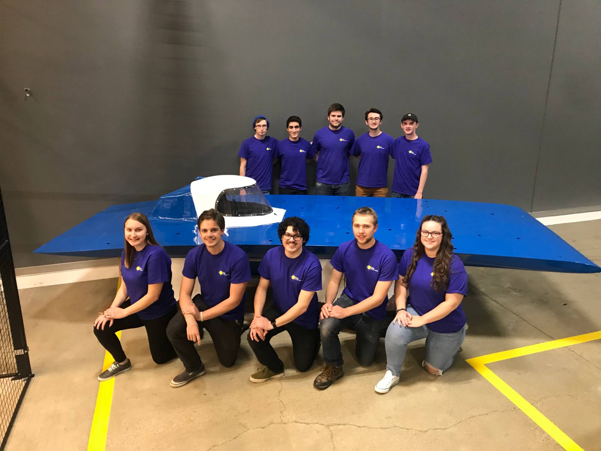 Students in front of the solar racing vehicle